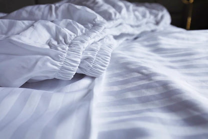 White stripped fitted white bedsheets